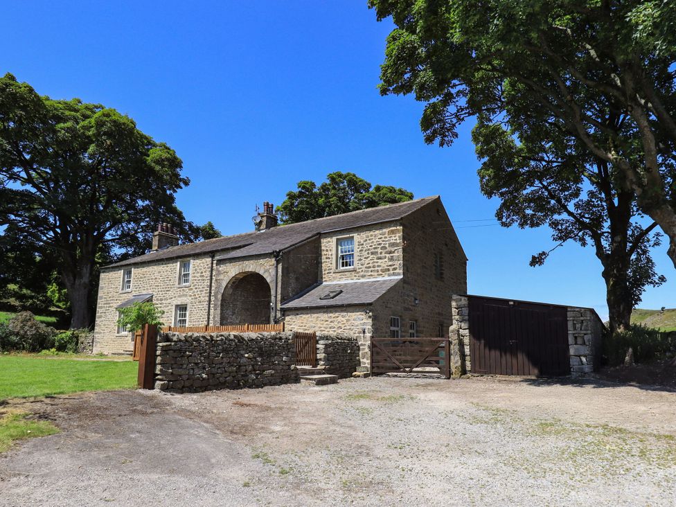 A house with trees and a gravel driveway at Ragged Hall Barn Settle