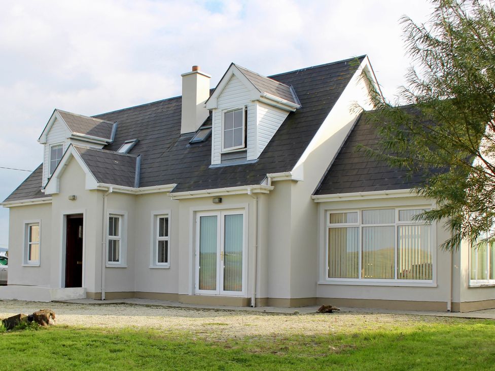 A house with multiple windows and a door at Welcome to the wild Atlantic way in Mulroy Bay