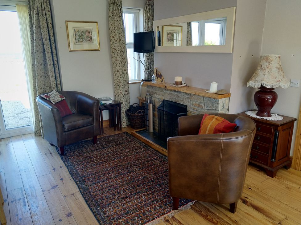 A living room with armchairs and a fireplace at Welcome to the wild Atlantic way Mulroy Bay