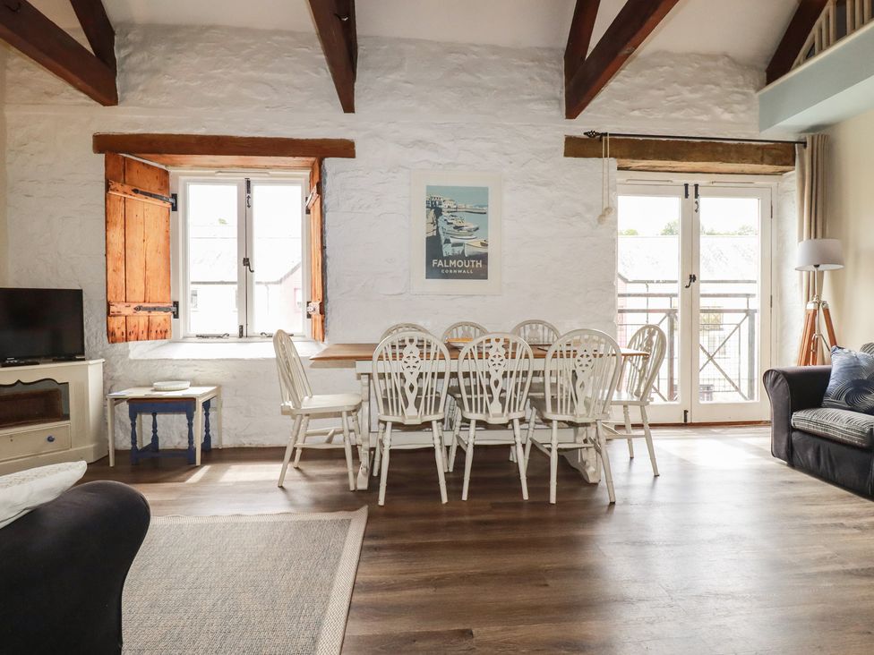 A living room with a dining table and chairs at Daniel’s Sail Loft Penthouse in Penryn