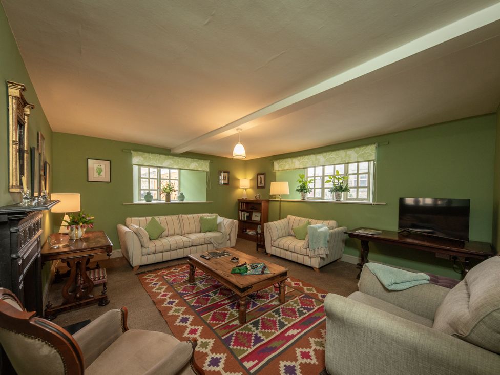 A living room with sofas and a table at Bishop Lightfoot Cottage, Bishop Auckland
