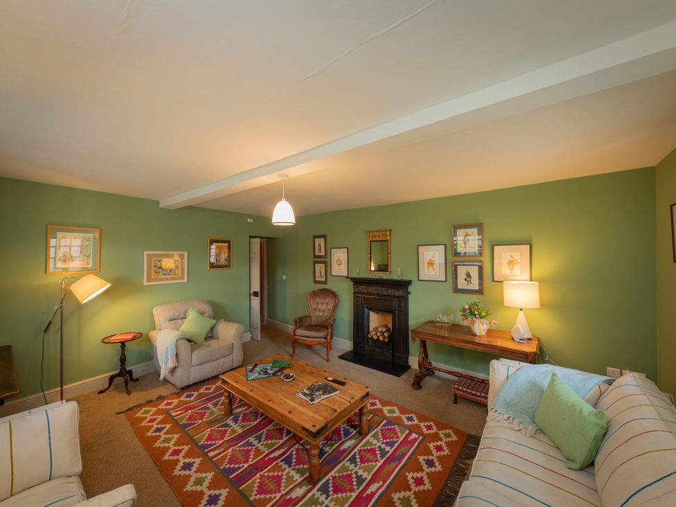 A living room with a coffee table and armchair at Bishop Lightfoot Cottage in Bishop Auckland