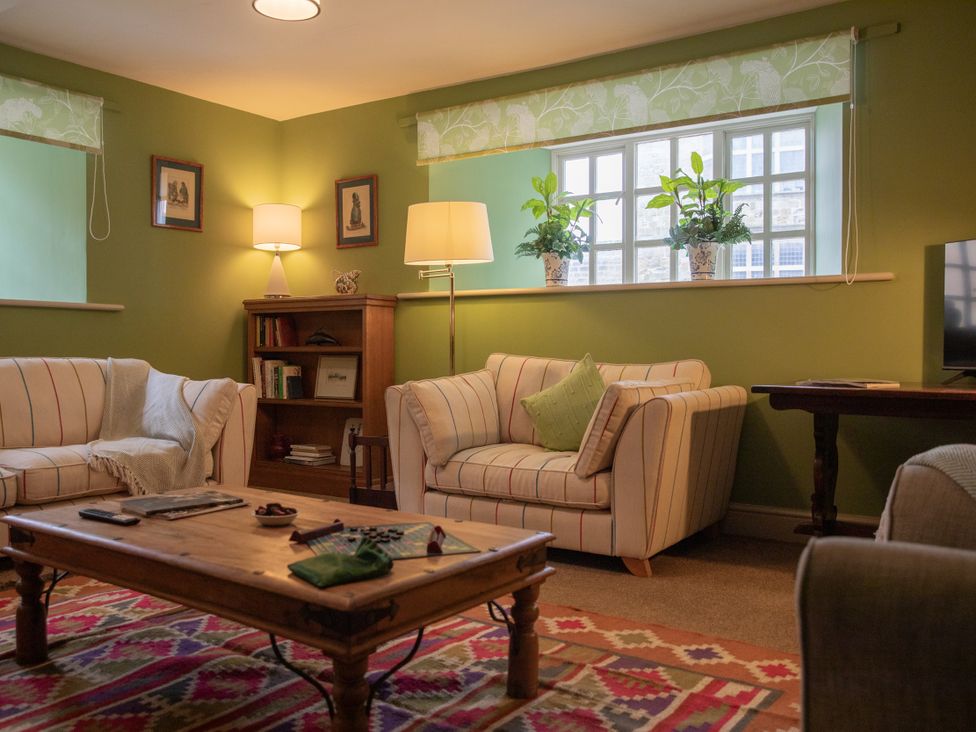 A living room with a sofa and coffee table at Bishop Lightfoot Cottage in Bishop Auckland