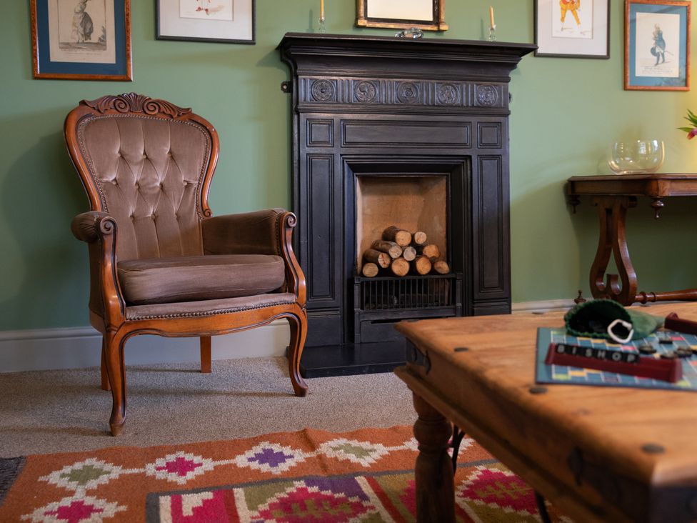 A living room featuring a chair and fireplace at Bishop Lightfoot Cottage Bishop Auckland