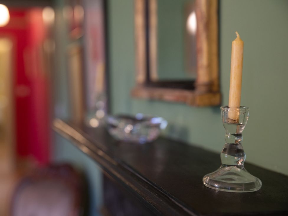A candle and holder on a mantel in Bishop Lightfoot Cottage, Bishop Auckland
