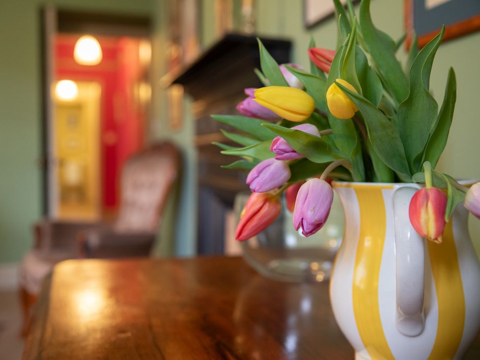 A living room with flowers in a vase at Bishop Lightfoot Cottage in Bishop Auckland