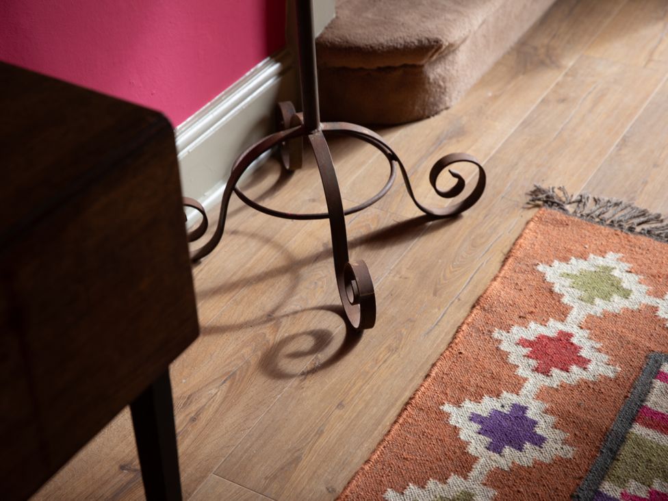 A living room with a stool and rug at Bishop Lightfoot Cottage in Bishop Auckland