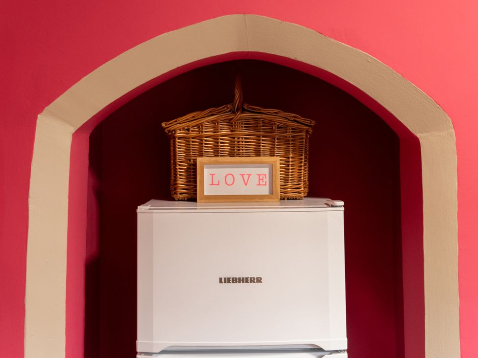 A fridge with a basket and sign on top at Bishop Lightfoot Cottage in Bishop Auckland