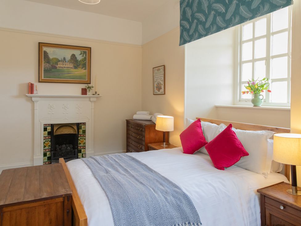 A bedroom with a bed and decorative items at Bishop Lightfoot Cottage in Bishop Auckland