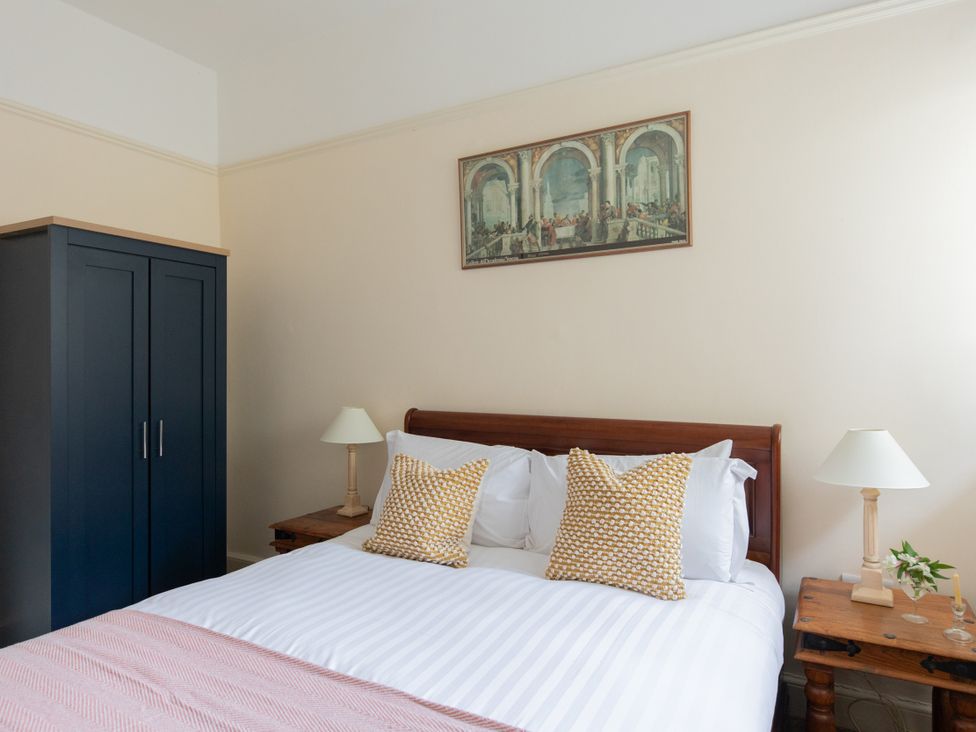 A bedroom with a bed and wardrobe at Bishop Lightfoot Cottage in Bishop Auckland