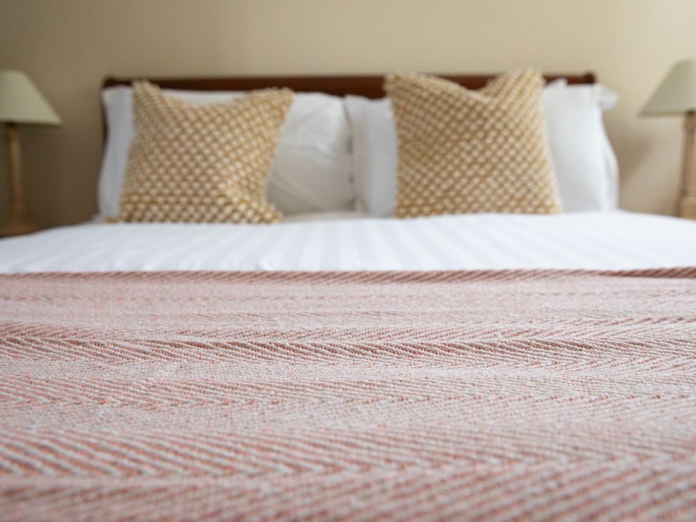 A bed with pillows and a lamp at Bishop Lightfoot Cottage in Bishop Auckland