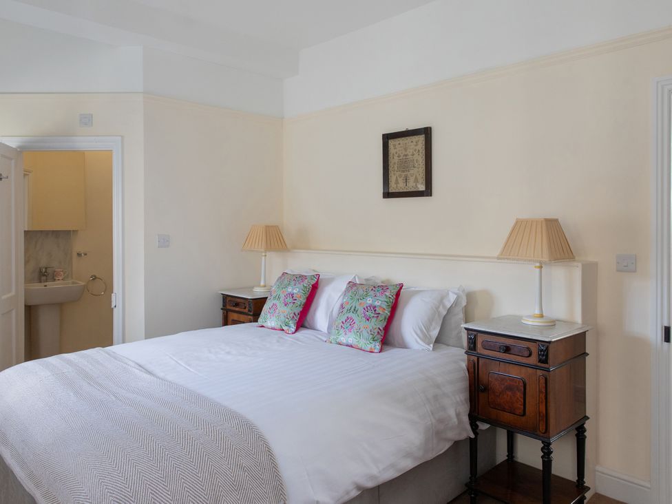 A bedroom with a bed and bedside tables at Bishop Lightfoot Cottage in Bishop Auckland