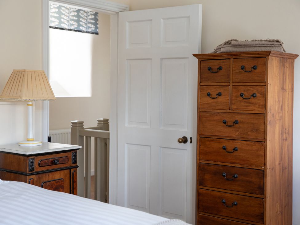 A bedroom with a chest of drawers and a lamp at Bishop Lightfoot Cottage in Bishop Auckland