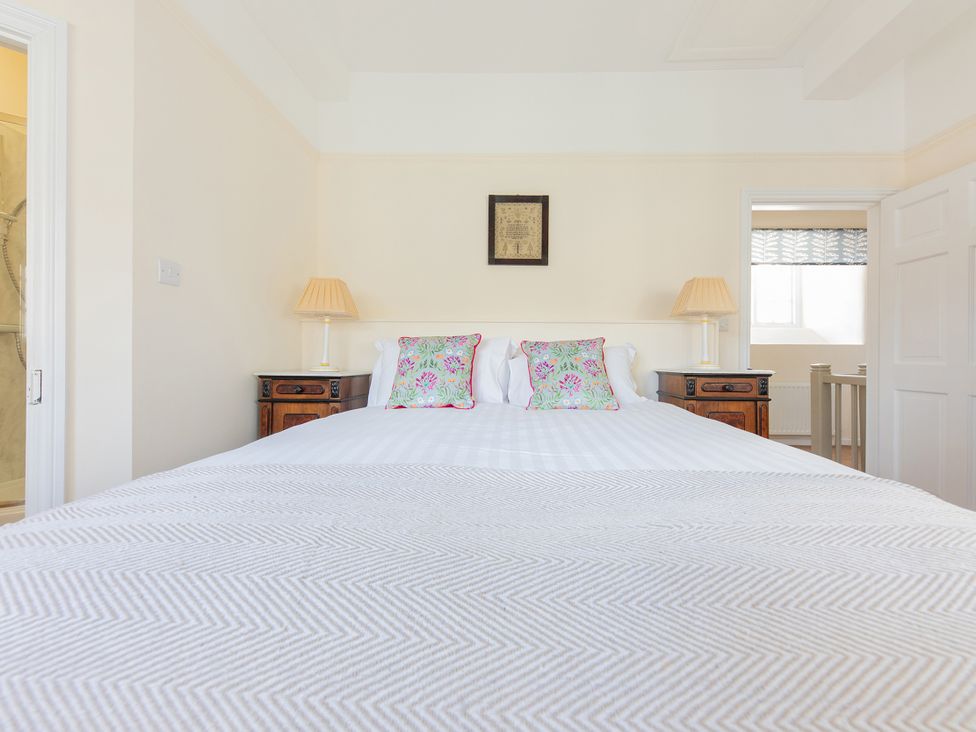 A bedroom with a bed and lamps at Bishop Lightfoot Cottage in Bishop Auckland