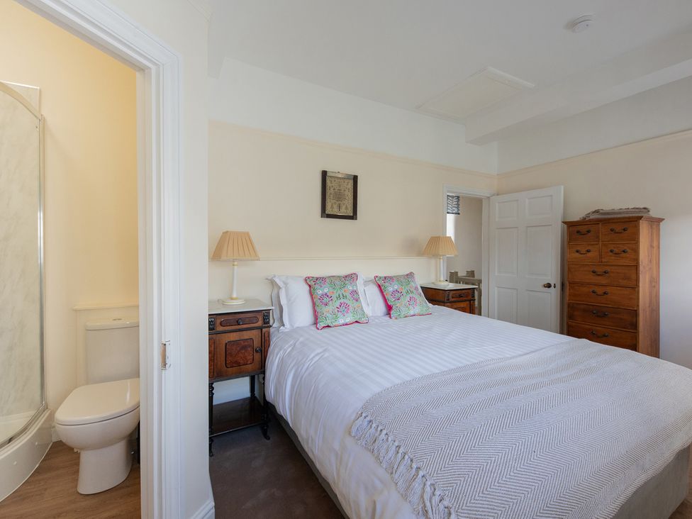 A bedroom with a bed and wardrobe at Bishop Lightfoot Cottage Bishop Auckland