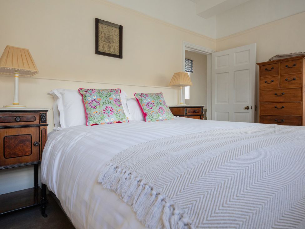 A bedroom with a bed and bedside tables at Bishop Lightfoot Cottage in Bishop Auckland