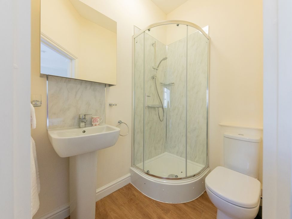 A bathroom with a shower, sink, and toilet at Bishop Lightfoot Cottage in Bishop Auckland