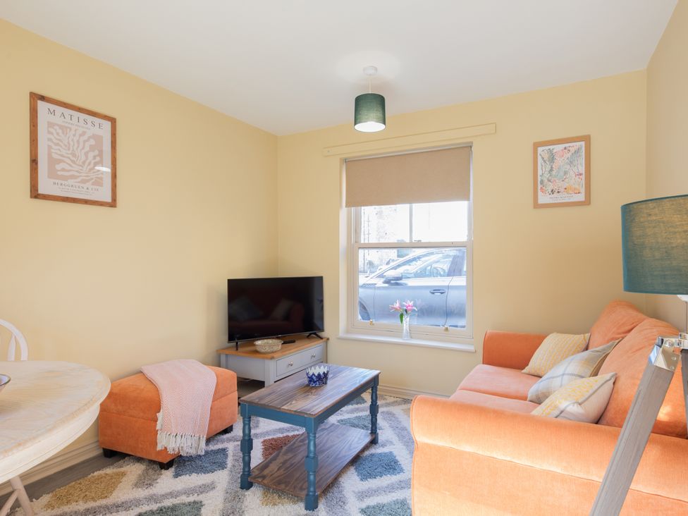 A living room with a sofa and TV at Sheriff's Tower Cottage - East, Bishop Auckland