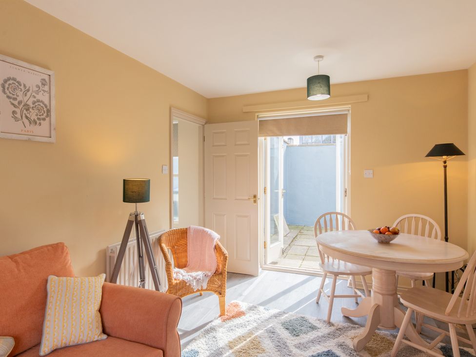 A living room with a table and chairs at Sheriff's Tower Cottage - Bishop Auckland