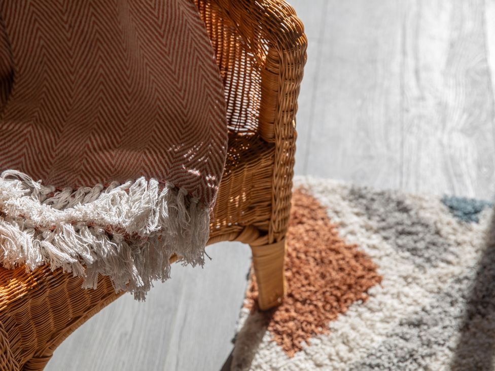 A chair with a blanket on it at Sheriff's Tower Cottage - East, Bishop Auckland