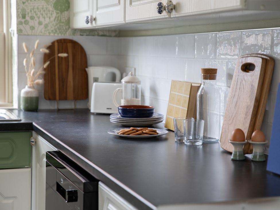 A kitchen with various items on the counter at Sheriff's Tower Cottage - East Bishop Auckland
