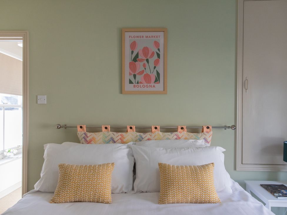 A bedroom with a bed and picture at Sheriff's Tower Cottage - East in Bishop Auckland