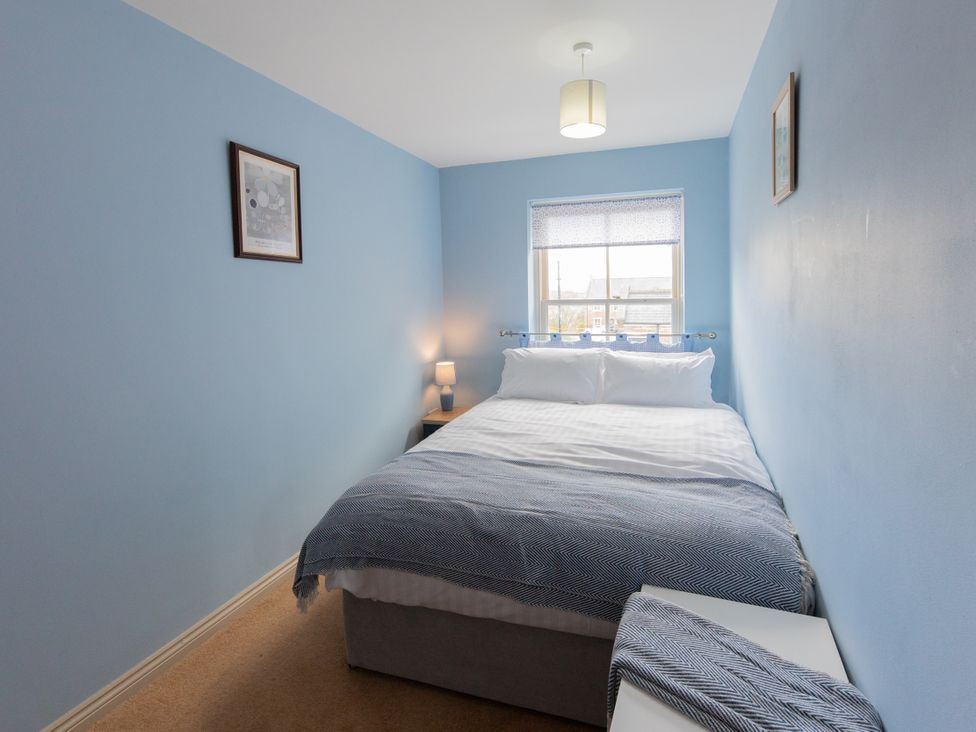A bedroom with a bed and bedside table at Sheriff's Tower Cottage - East in Bishop Auckland