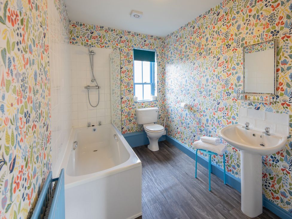 A bathroom with a bathtub, sink, and toilet at Sheriff's Tower Cottage - East in Bishop Auckland