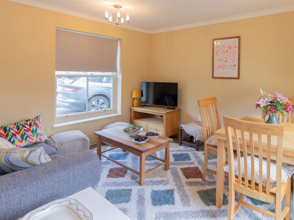 A living room with a sofa and dining table at Sheriff's Tower Cottage - West Bishop Auckland