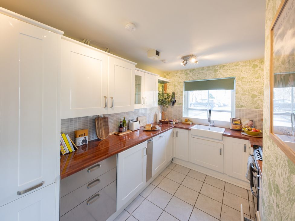 A kitchen with cabinets and a sink at Sheriff's Tower Cottage - West Bishop Auckland