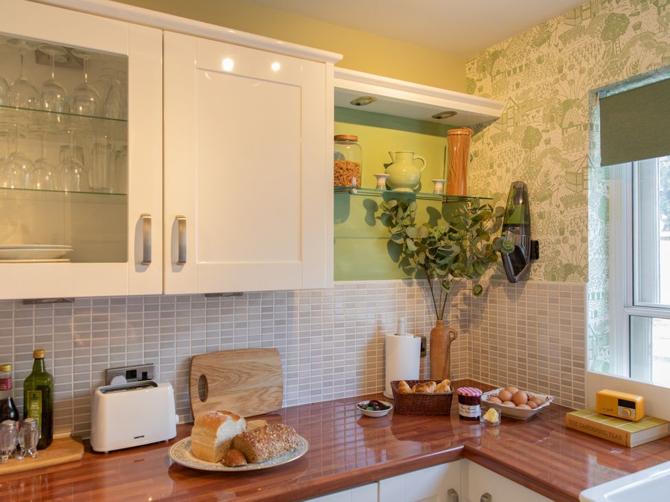 A kitchen with cabinets and a countertop at Sheriff's Tower Cottage - West in Bishop Auckland