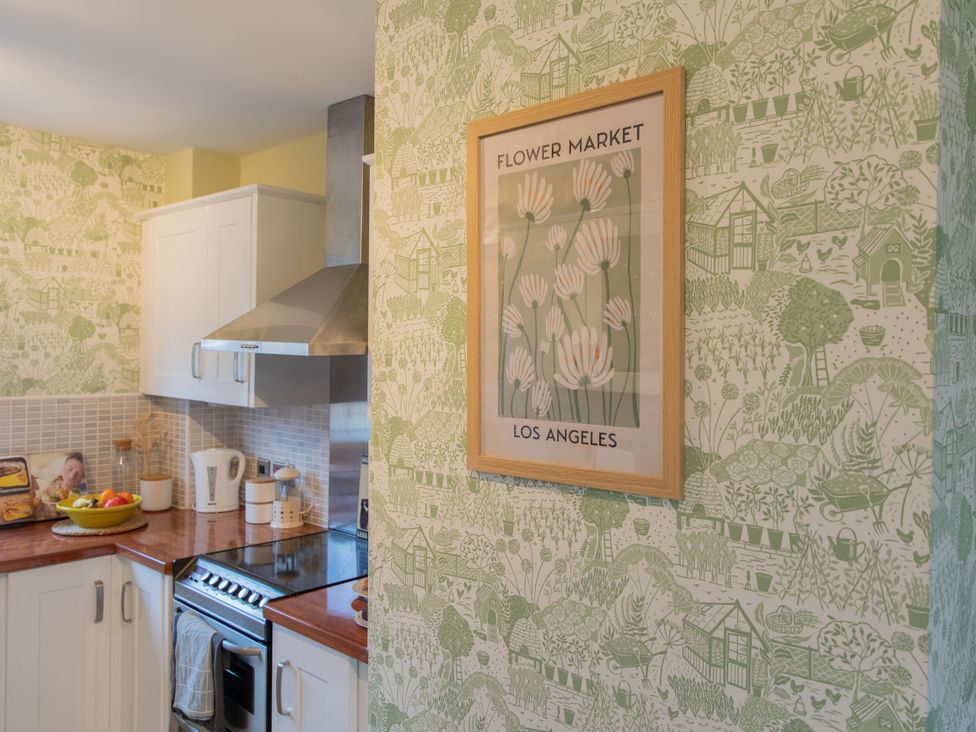 A kitchen with a stove and fruit bowl at Sheriff's Tower Cottage - West, Bishop Auckland