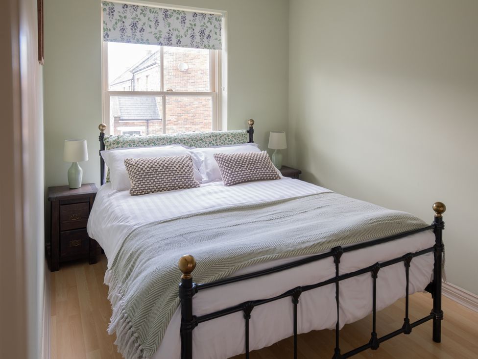 A bedroom with a bed and bedside table at Sheriff's Tower Cottage - West Bishop Auckland