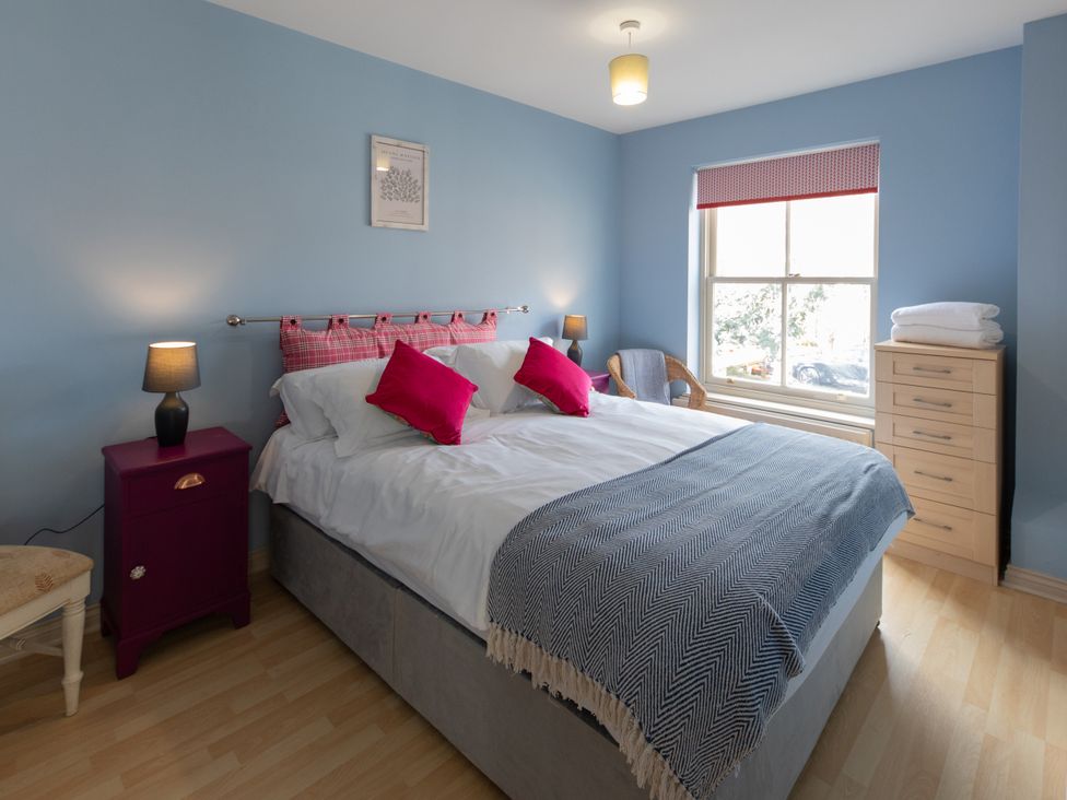 A bedroom with a bed and bedside table at Sheriff's Tower Cottage - West in Bishop Auckland