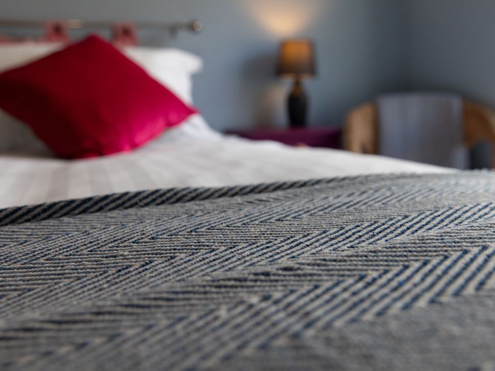 A bedroom with a bed and lamp at Sheriff's Tower Cottage - West in Bishop Auckland
