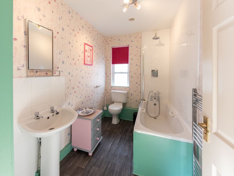 A bathroom with a bathtub and sink at Sheriff's Tower Cottage - West in Bishop Auckland