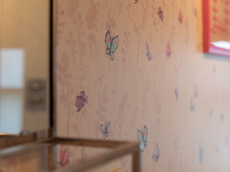 A wall with butterfly pattern at Sheriff's Tower Cottage - West in Bishop Auckland