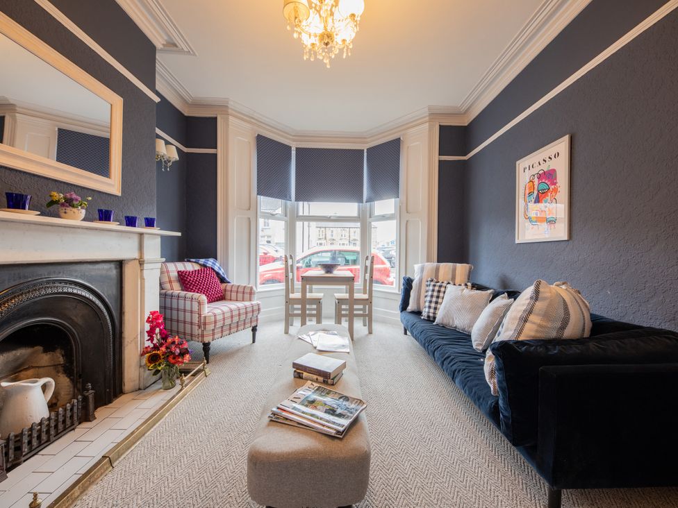A living room with a sofa, armchair, and coffee table at No 2 Townhouse in Bishop Auckland