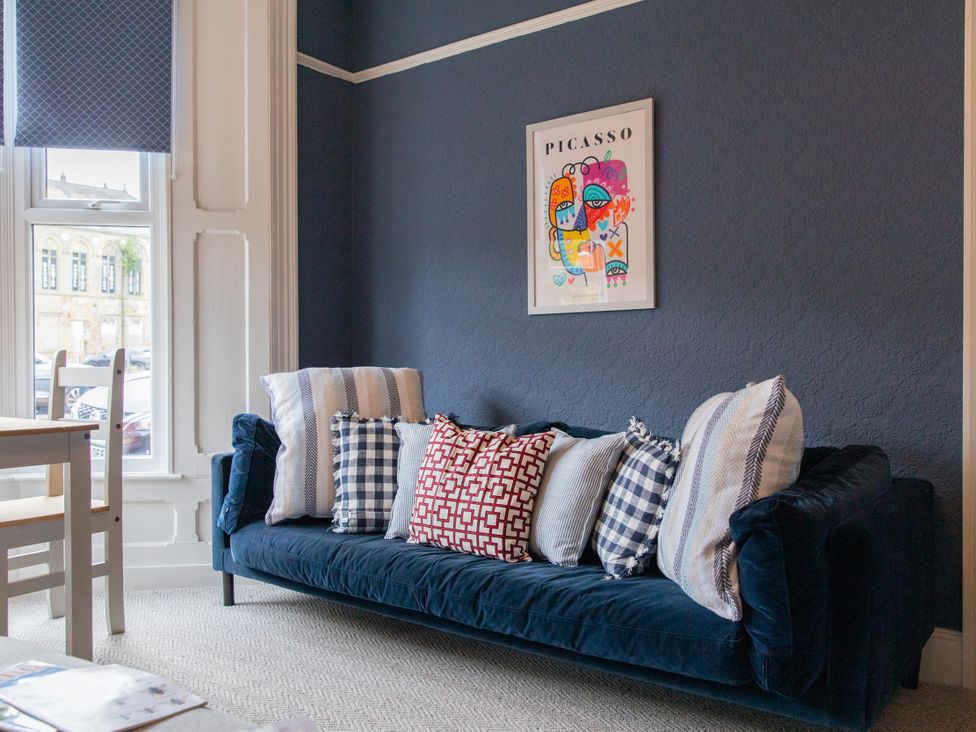 A living room with a sofa and wall art at No 2 Townhouse, Bishop Auckland