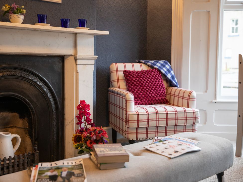 A living room with an armchair and fireplace at No 2 Townhouse in Bishop Auckland