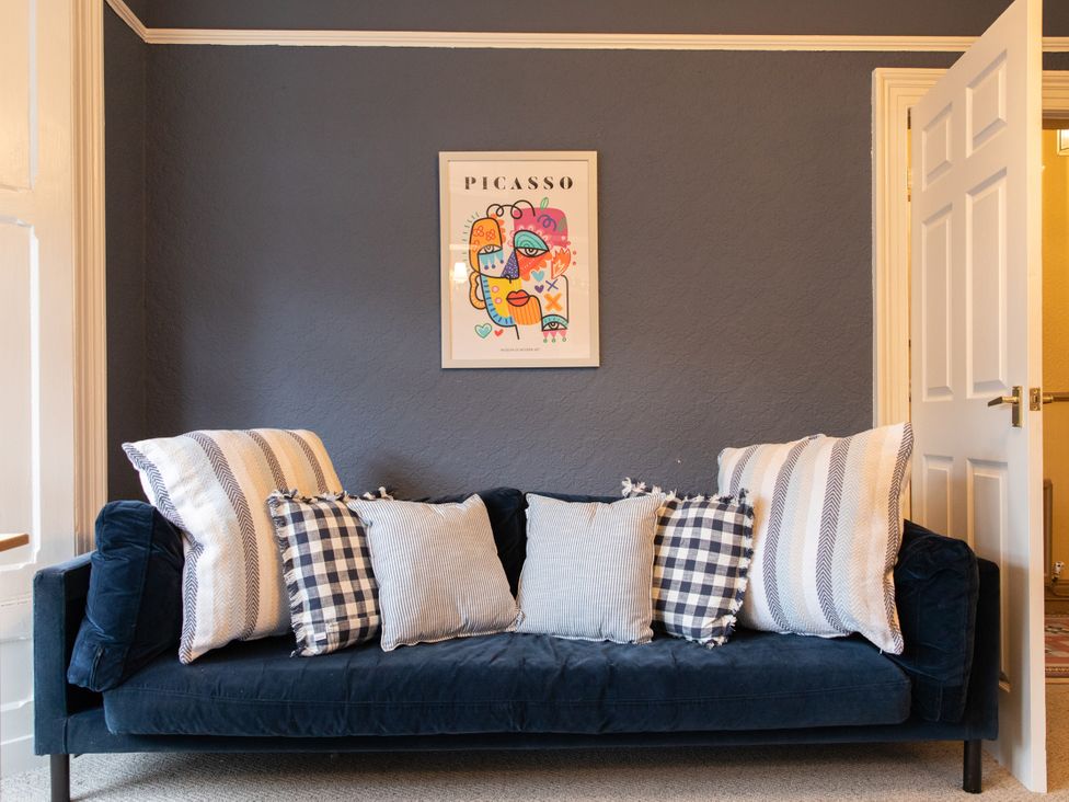 A sofa with cushions in a living room at No 2 Townhouse in Bishop Auckland