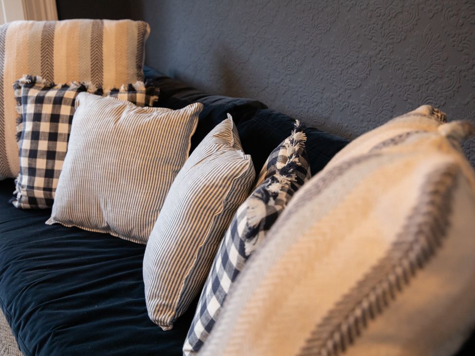 A sofa with cushions at No 2 Townhouse in Bishop Auckland