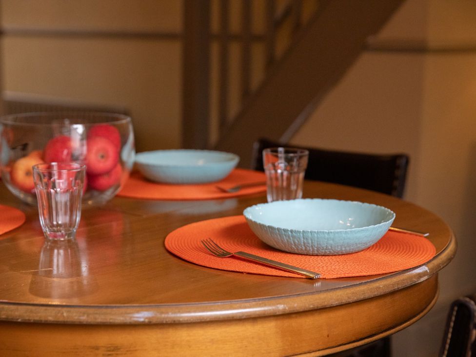 A dining table set with plates and glasses at No 2 Townhouse in Bishop Auckland