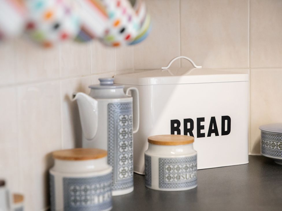 A kitchen counter with a bread bin and canisters at No 2 Townhouse in Bishop Auckland