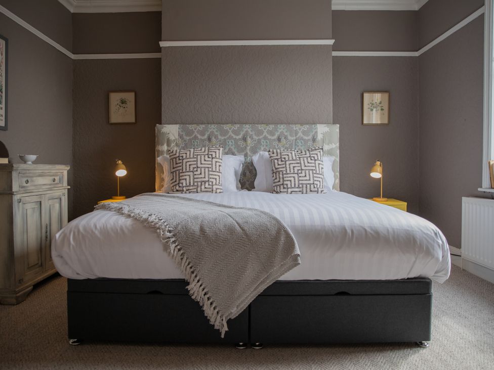 A bedroom with a bed and bedside lamp at No 2 Townhouse in Bishop Auckland