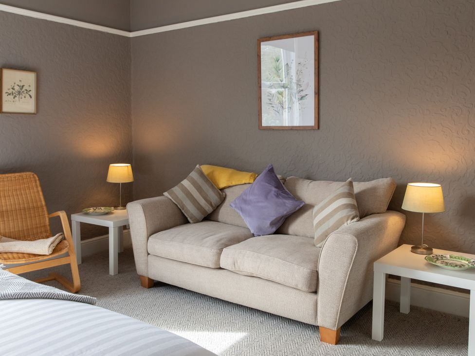 A living room with sofa and side tables at No 2 Townhouse in Bishop Auckland