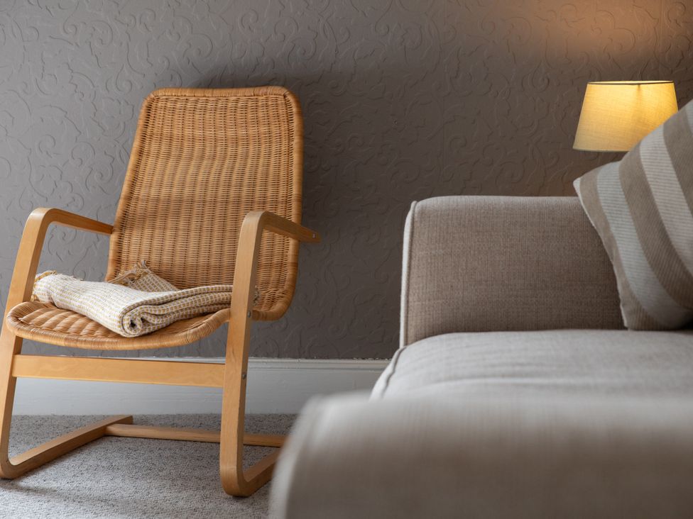 A living room with a rocking chair and a sofa at No 2 Townhouse in Bishop Auckland