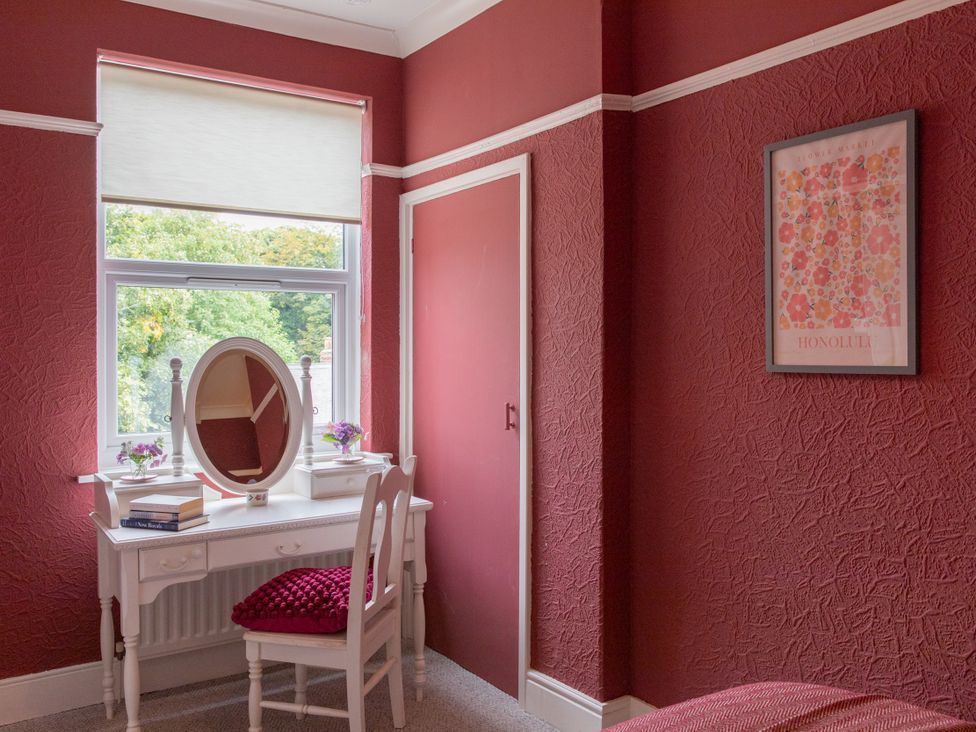 A bedroom with a vanity table and chair at No 2 Townhouse in Bishop Auckland