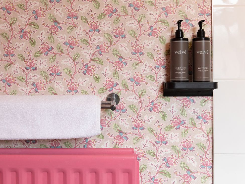 A bathroom with a towel and shampoo at No 2 Townhouse in Bishop Auckland
