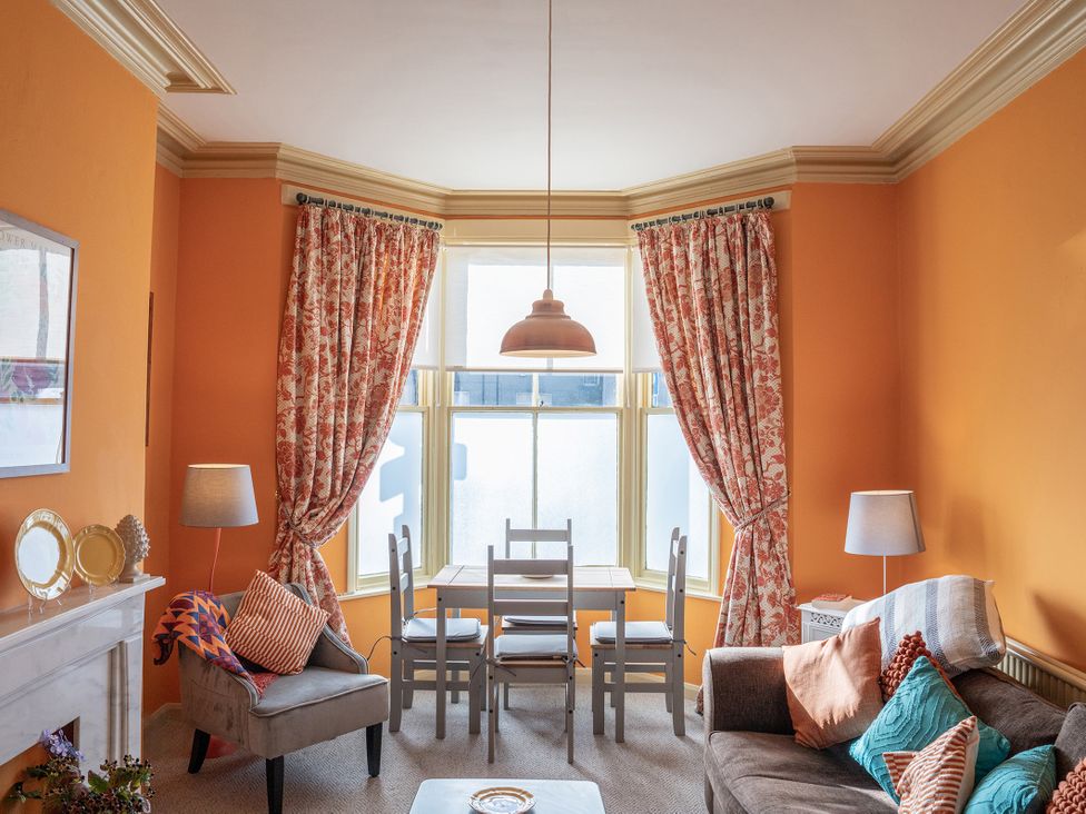 A living room with a table and chairs next to a sofa at No 4 Townhouse in Bishop Auckland
